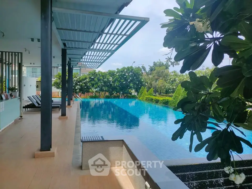 Luxurious outdoor pool area with lush greenery and modern design, perfect for relaxation and leisure.