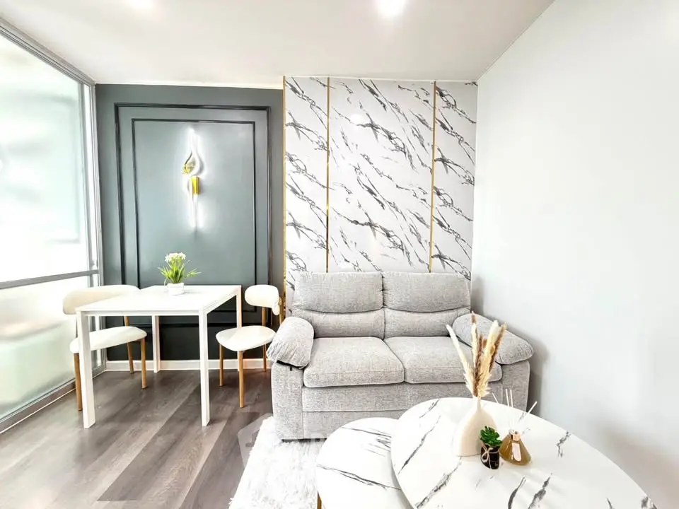 Modern living room with stylish marble accents and cozy seating area