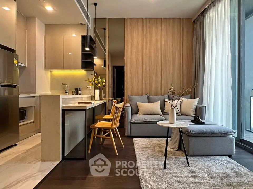 Modern open-layout living room with stylish kitchen and cozy seating area, featuring floor-to-ceiling windows.