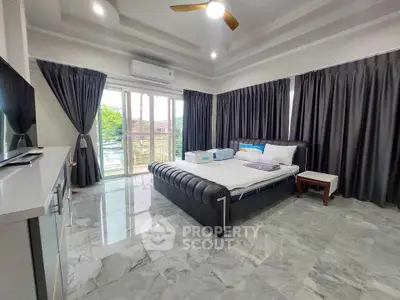 Spacious bedroom with elegant marble flooring and large windows offering natural light.
