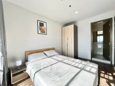Bright and cozy bedroom with modern decor and ample natural light.