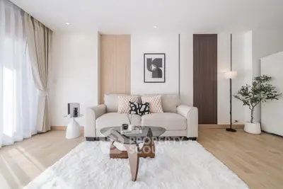 Modern living room with stylish decor, featuring a cozy sofa, elegant coffee table, and chic wall art.
