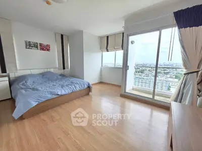 Spacious bedroom with city view and balcony access in modern apartment