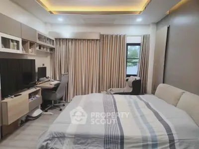 Modern bedroom with cozy bed, stylish desk, and elegant lighting