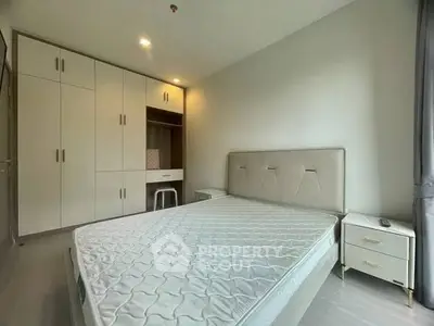 Modern bedroom with built-in wardrobe and stylish bed in a bright apartment.