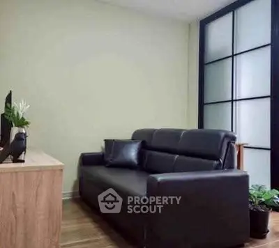Modern living room with sleek black sofa and stylish decor