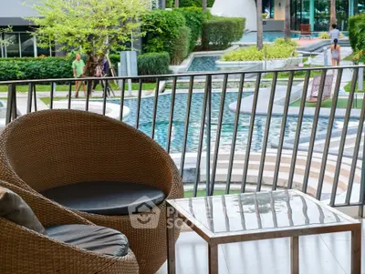 Luxurious balcony view overlooking a serene pool and lush garden, perfect for relaxation and leisure.