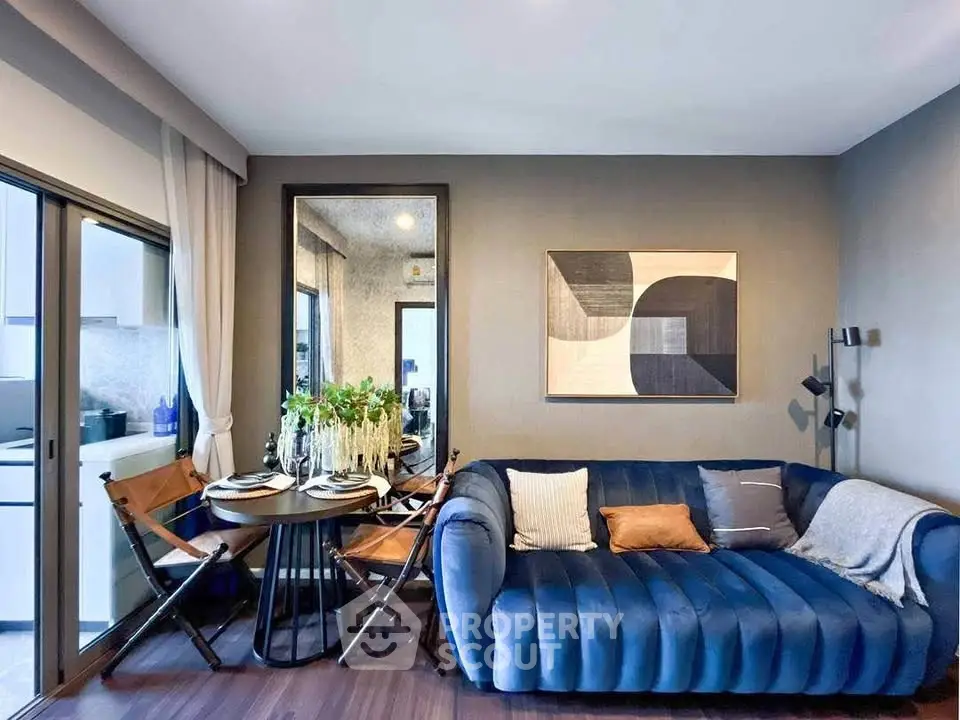 Stylish modern living room with blue velvet sofa and chic dining area