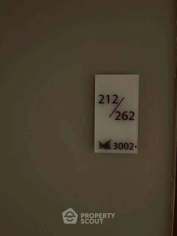 Apartment door number sign with unit numbers 212 and 262