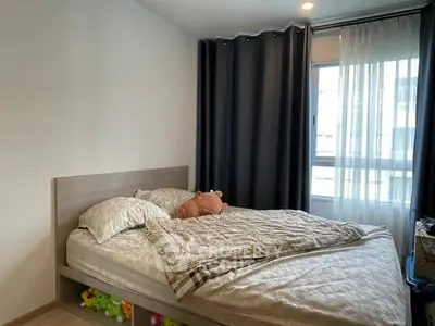 Cozy bedroom with modern decor and large window for natural light