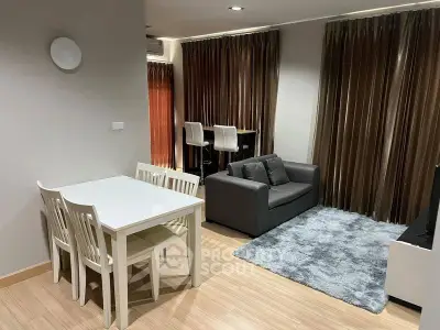 Modern living room with dining area, featuring sleek furniture and elegant curtains.