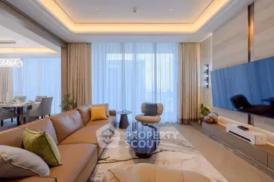Luxurious modern living room with elegant decor and large TV, perfect for relaxation and entertainment.