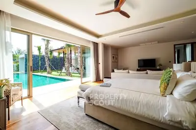 Luxurious bedroom with pool view and modern decor in a tropical villa.