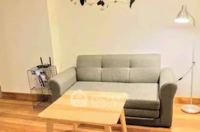 Cozy living room with modern sofa and stylish decor, perfect for relaxation.