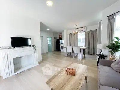 Spacious living room with modern decor and dining area, featuring natural light and elegant furnishings.