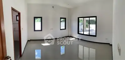 Spacious empty room with large windows and glossy tiled floor, perfect for customization.