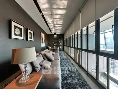 Luxurious modern living room with panoramic city views and elegant decor.