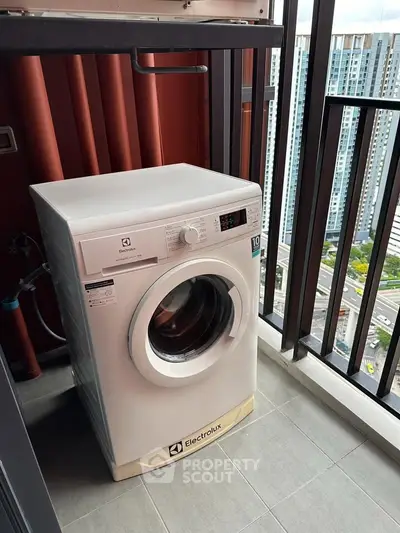 Modern apartment balcony with washing machine and city view