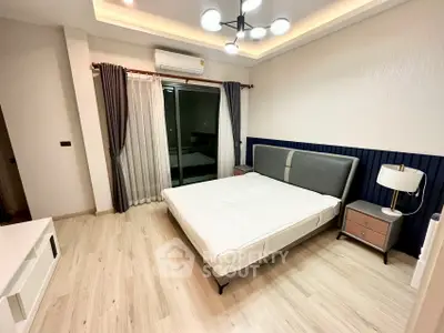 Modern bedroom with stylish lighting and sleek furnishings in a contemporary apartment.