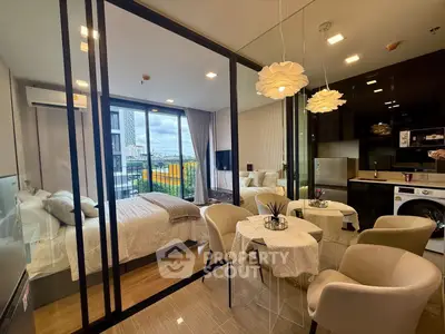 Modern studio apartment with glass partition, cozy dining area, and city view balcony.