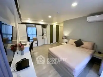 Spacious modern bedroom with elegant decor and ample natural light