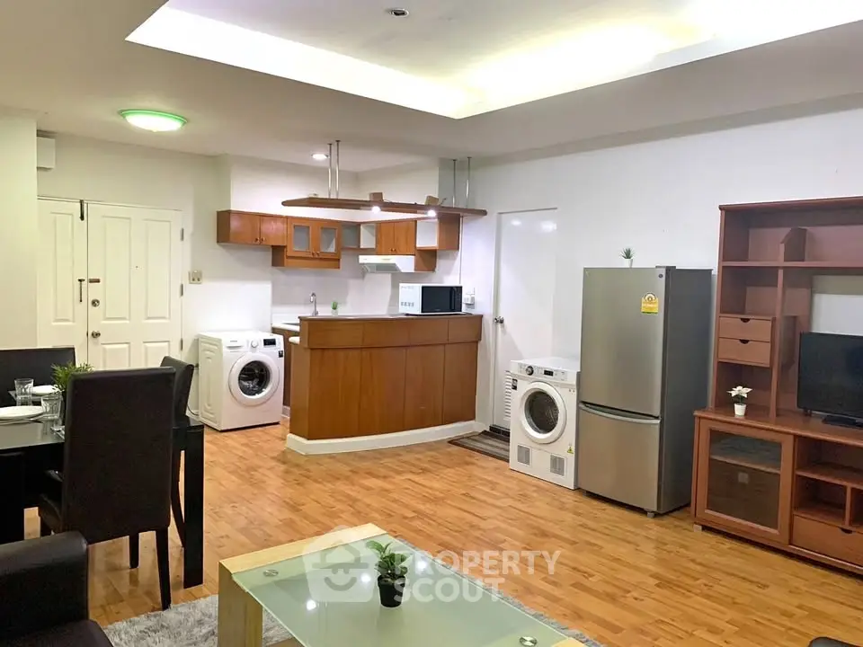 Spacious open-plan living area with modern kitchen and appliances.