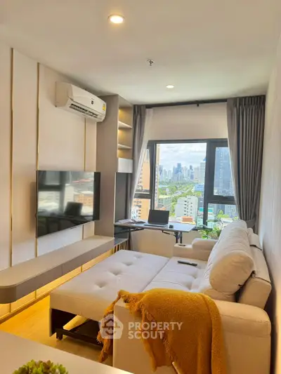 Modern living room with city view, featuring cozy sofa and wall-mounted TV.