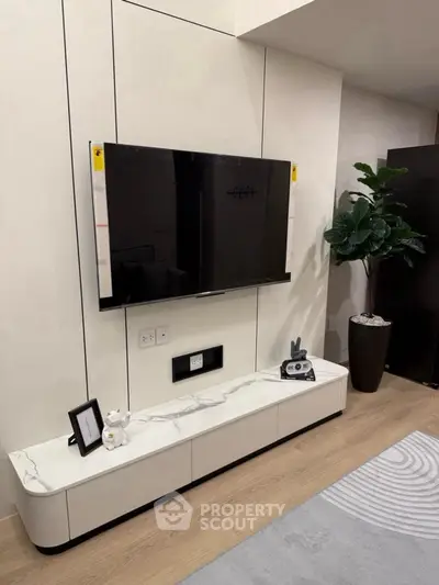 Modern living room with wall-mounted TV and sleek marble console