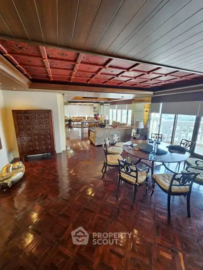 Luxurious living room with elegant wooden ceiling and spacious seating area, perfect for entertaining.