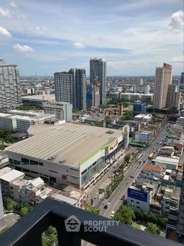 Stunning cityscape view from high-rise balcony overlooking urban skyline and bustling streets.