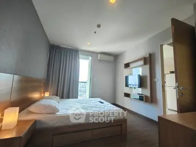 Modern bedroom with stylish decor and natural light in a high-rise apartment.