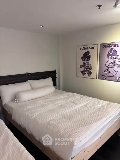 Cozy bedroom with stylish decor and comfortable bedding in modern apartment.