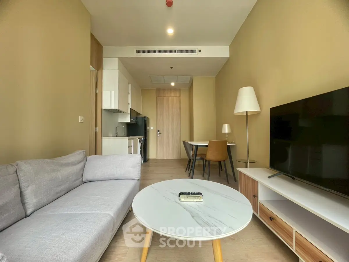 Modern living room with sleek furniture and open layout in a stylish apartment.