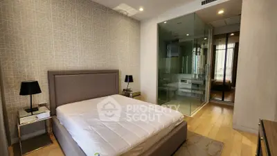 Modern bedroom with glass-enclosed shower and stylish decor