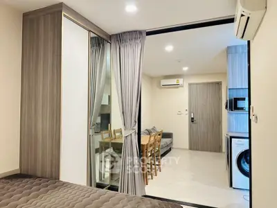 Modern apartment interior with open layout, featuring a cozy living area and stylish kitchen.