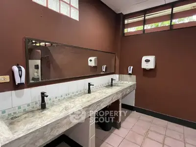 Spacious public restroom with modern fixtures and ample lighting