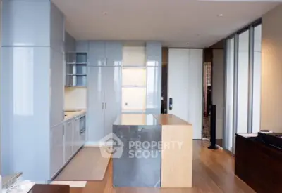 Modern kitchen with sleek cabinetry and island in luxury apartment
