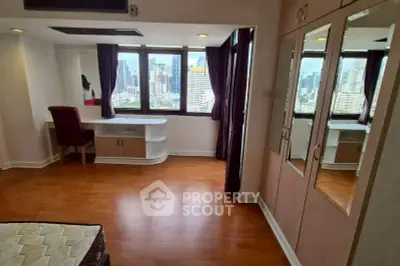 Spacious bedroom with city view, hardwood floors, and built-in wardrobe in modern apartment.