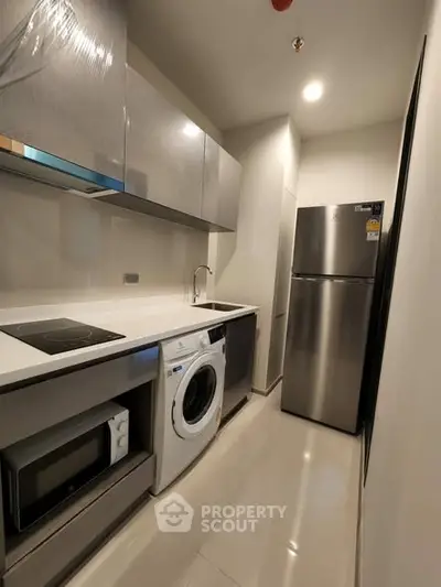 Modern kitchen with sleek appliances and compact design