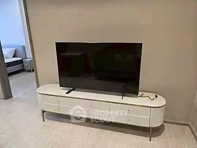 Modern living room with sleek TV stand and flat-screen television, perfect for entertainment.