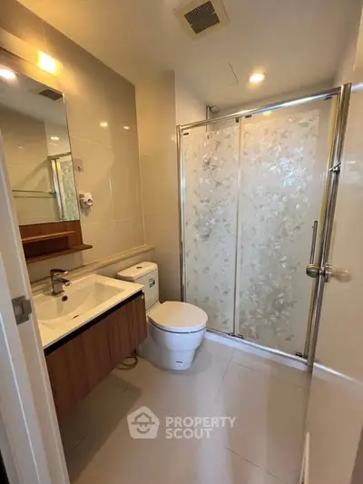 Modern bathroom with sleek fixtures and glass shower enclosure