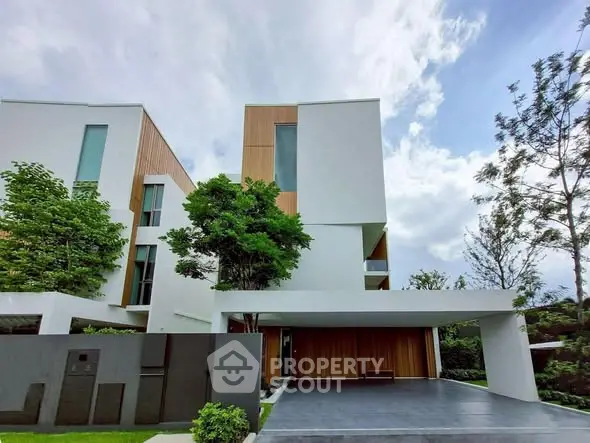 Modern architectural masterpiece with sleek design and lush greenery, offering luxury living in a serene environment.
