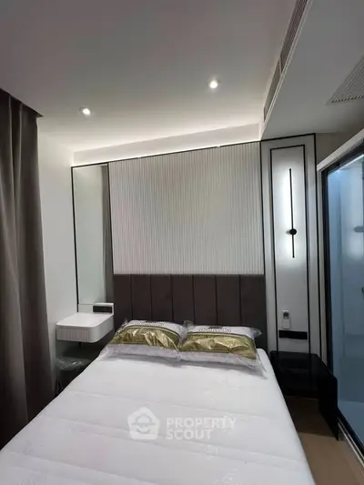 Modern bedroom with elegant design and ambient lighting, featuring a cozy bed and stylish decor.