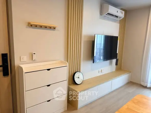 Modern living room with wall-mounted TV and air conditioning unit
