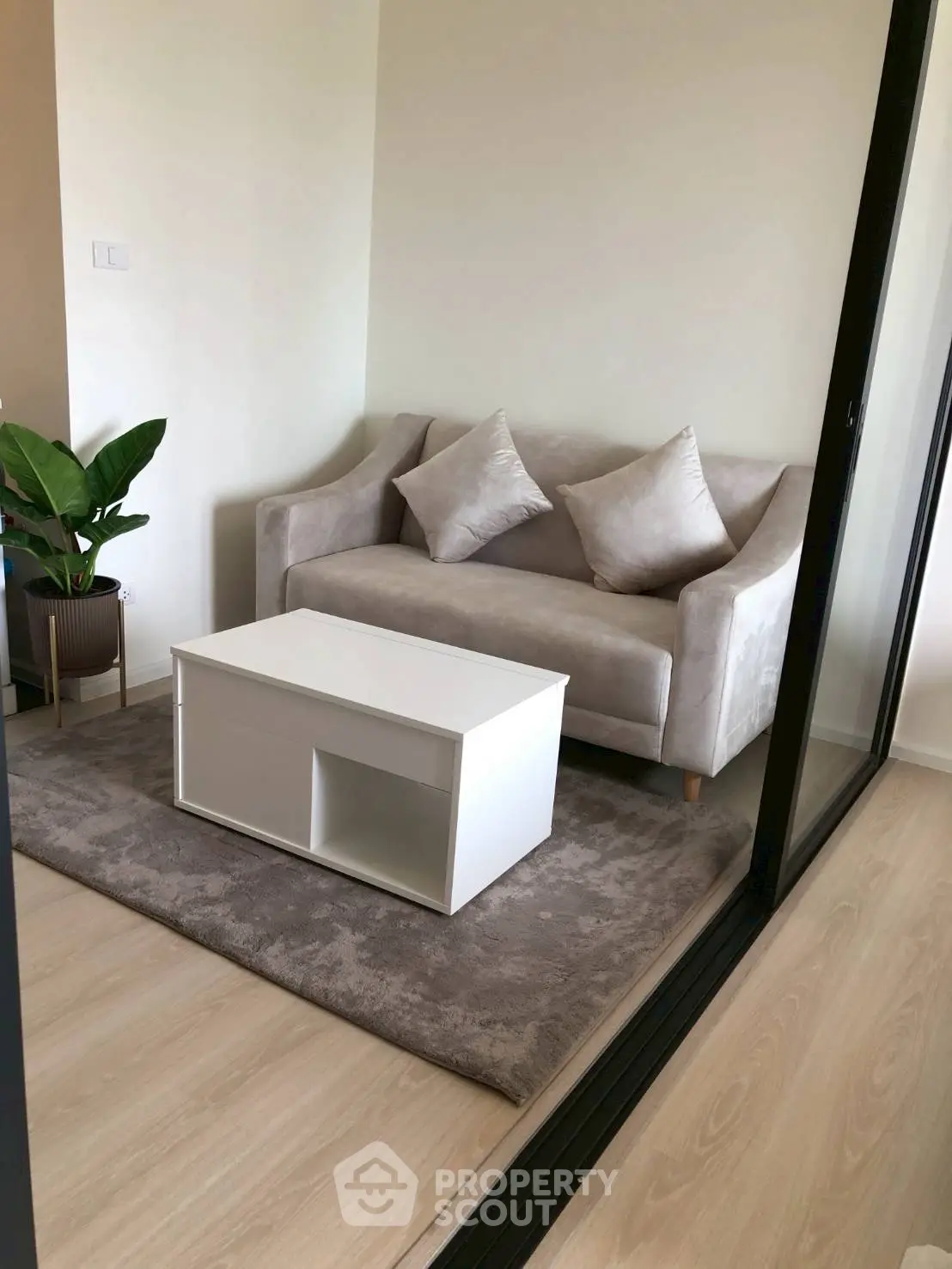 Cozy living room with plush sofa and modern coffee table on soft rug