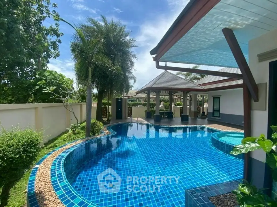 Luxurious villa with stunning private pool and lush garden, perfect for tropical living.