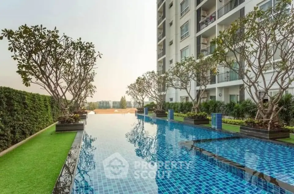 Luxurious apartment building with stunning pool and lush greenery