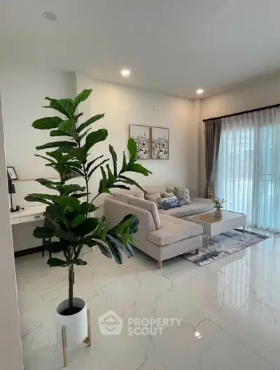 Elegant living room with modern decor and large windows for natural light.