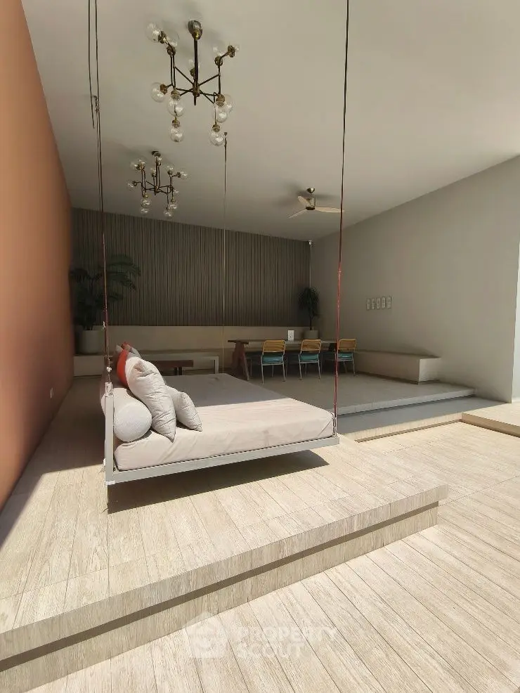 Modern living room with stylish suspended seating and elegant dining area.