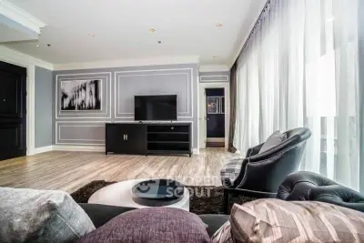 Spacious modern living room with elegant decor and large windows for natural light.